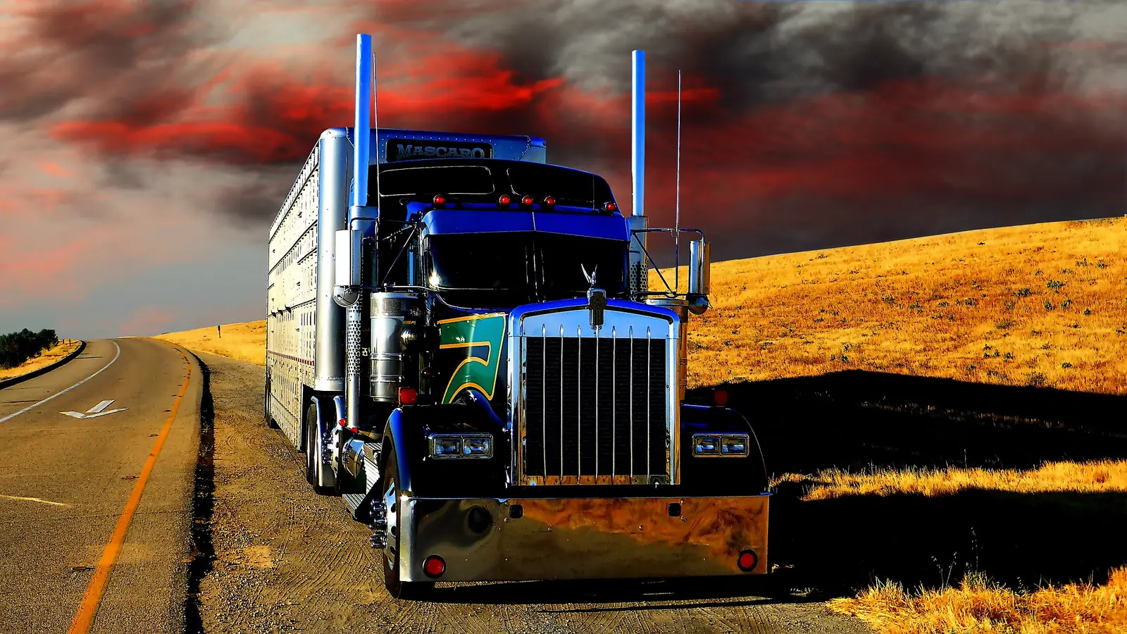 Classic blue Kenworth W900 long-hood tractor on the open road — Bledsoe Truck & Trailer Repair has earned the trust of independent owner-operators across Oklahoma.