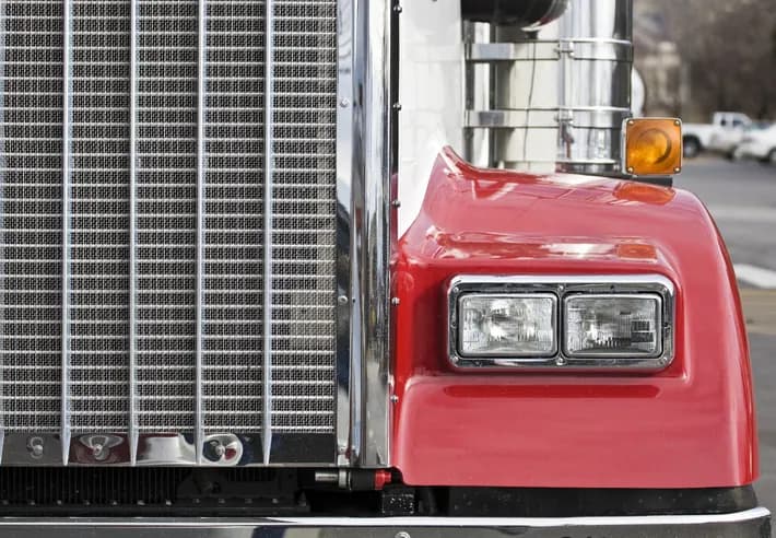 Cooling system and electrical repair — Bledsoe Truck & Trailer Repair, OKC Heavy-duty truck radiator, chrome grille, and headlight detail — Bledsoe's Oklahoma City shop repairs cooling systems, charging systems, and front-end electrical for semi trucks.